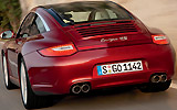 Porsche 911 Targa. Modelo 2009. Imagen. Posterior. Techo acristalado. Coche en movimiento. Carretera. Rojo rub� metalizado. 