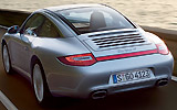 Porsche 911 Targa. Modelo 2009. Imagen. Exterior. Lateral posterior. Coche en movimiento. Carretera. Gris.