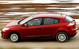 Renault Megane. Modelo 2009. Imagen. 5 puertas. Lateral. Coche en movimiento. Carretera. Rojo.