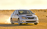Subaru Impreza Sed�n. Modelo 2009. Frontal lateral. Movimiento. Coche gris